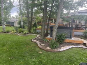 Decorative concrete landscape edging installed in a backyard by Premier Edge Concrete in Grand Rapids, MI