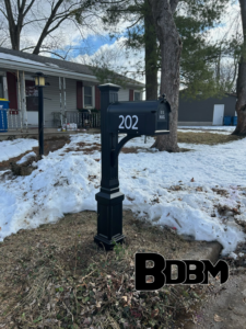 A decorative black mailbox with house number 202 installed by Big Dicks Brick Mailboxes in St. Louis, MO.