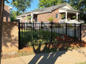 Decorative black metal fence with brick columns installed by BZB Fencing & Staining in Fountain Inn, SC.