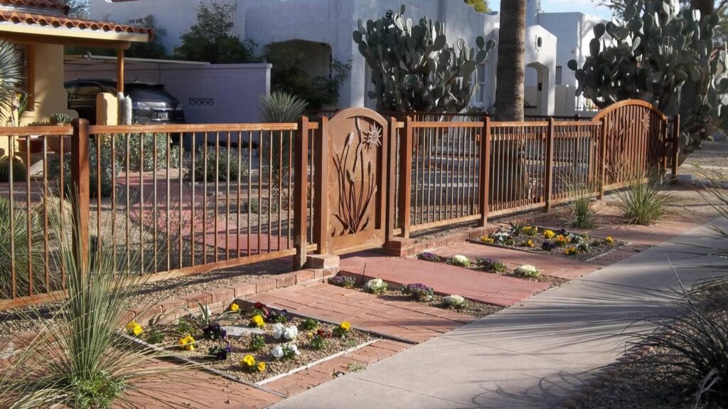 A decorative metal fence and gate installed along a sidewalk by Affordable Fence & Gates in Tucson, AZ.