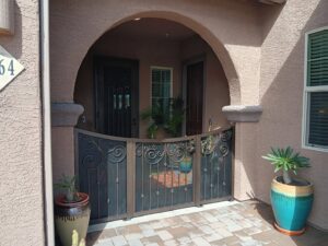 A decorative metal gate enclosing a patio area installed by Affordable Fence & Gates in Tucson, AZ.