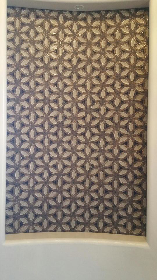 A decorative mosaic tile wall featuring a unique pattern installed by Clayton Family Tile, LLC in Chandler, AZ
