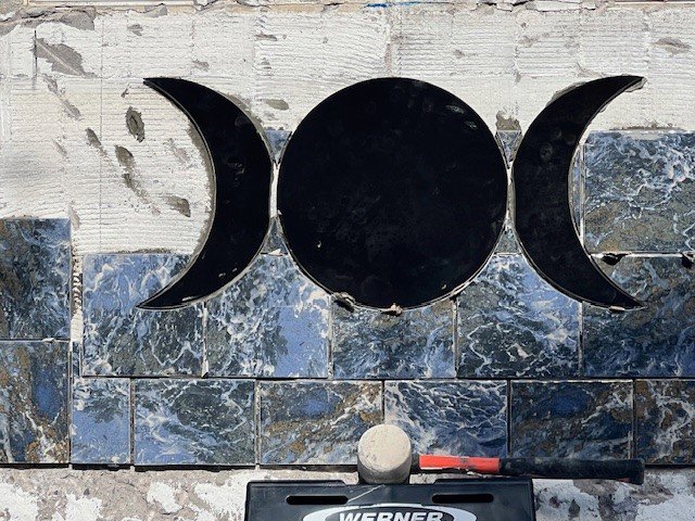 Decorative tile work being installed on a pool wall, a custom renovation service by Aqua Squad Pools & Landscaping in Gilbert, AZ.