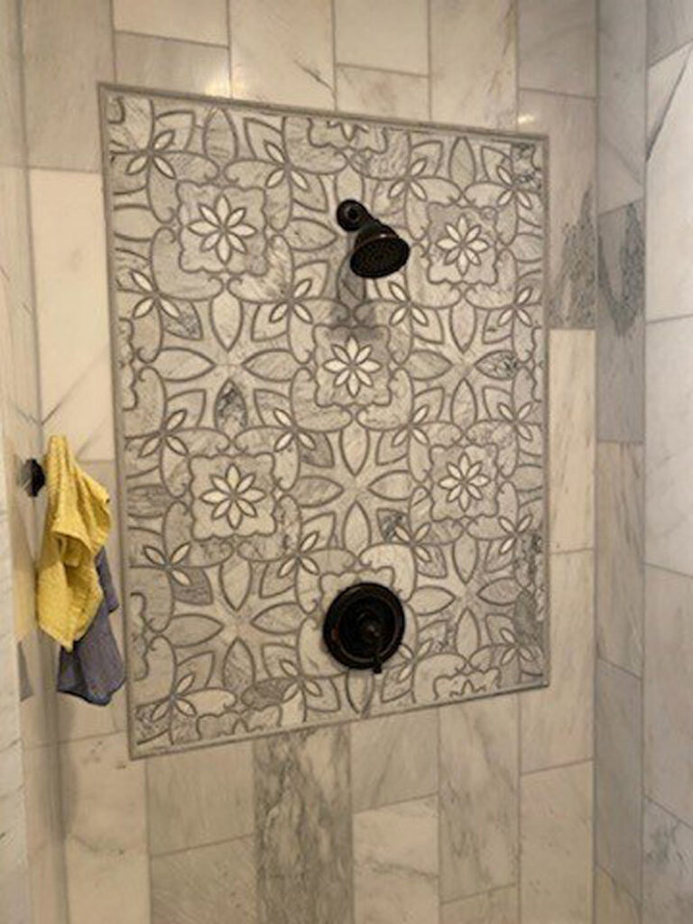 Close-up of a decorative patterned shower tile installation completed by Falls Contracting, LLC in Raleigh, NC.