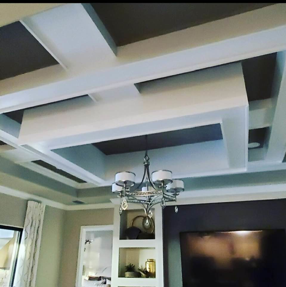 An elegant decorative tray ceiling and built-in shelving in a living area by Catalyst Contracting in Cape Coral, FL.