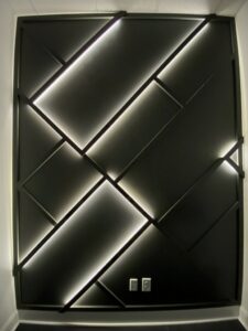 A decorative wall panel with geometric patterns and integrated LED lighting, a custom installation by Huff Consolidated Enterprises LLC in Clarksville, TN.