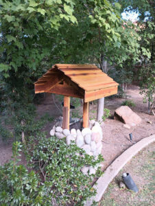Decorative wishing well construction in a garden by Carpenter Joe's Handyman Service in Sacramento, CA
