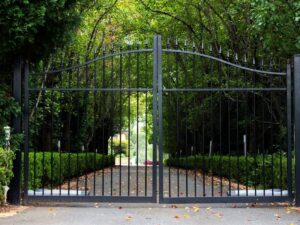 A decorative black wrought iron style gate installed by Tin Star Fencing in Fort Worth, TX