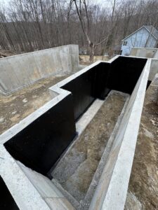 A deep foundation trench with waterproofing membrane applied by ProSeal Waterproofing in Naugatuck, CT.