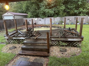 Piles of demolished wooden deck debris ready for removal by Weekly Waste Solutions in Jackson, MS.