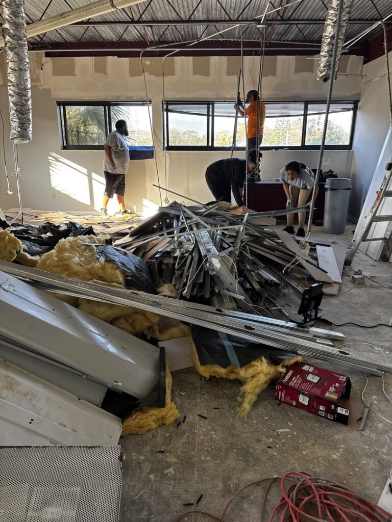 Demolition debris, including metal and insulation, being cleared from a commercial space by DUMP 4 U Hauling in Jacksonville, FL.