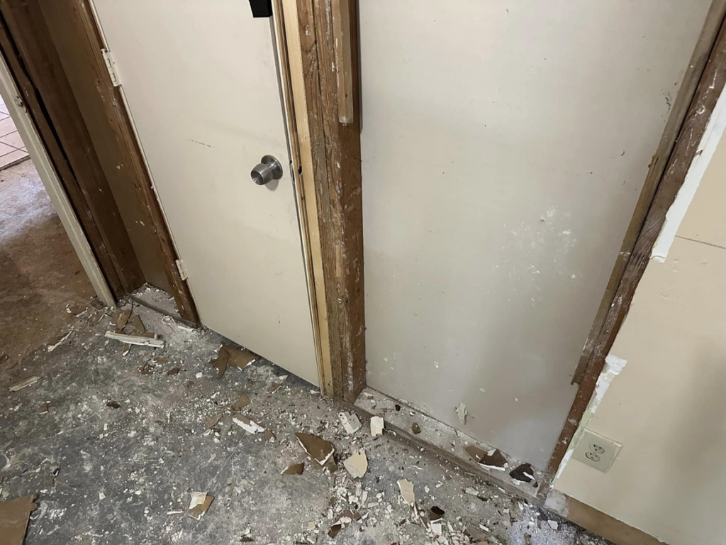 Interior renovation showing demolition debris and exposed framing by Snell & Sons Construction LLC in Mobile, AL.