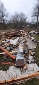 A large pile of demolition debris, including wood and insulation, on the ground, indicating a post-demolition junk removal service by Trash Monkey Junk Removal in Charleston, WV.