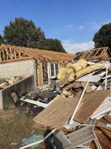 A large pile of demolition debris, including insulation and wood, from a house cleanout by DC'S Removal Service in Neelyville, MO.