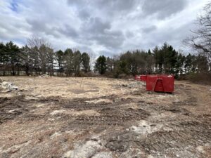 A demolition site with debris and dumpsters for cleanup by Insta Junk Removal & Demolition LLC in Salisbury, MD
