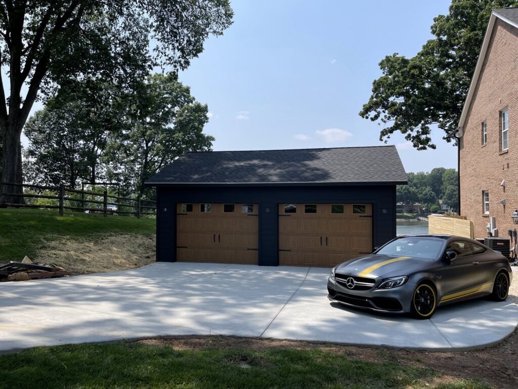 Detached garage with two wooden-style garage doors installed by Total Garage Works in Indian Trail, NC.