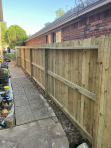 A detailed view of a new wooden privacy fence, expertly constructed by Triple A' Construction in San Antonio, TX.
