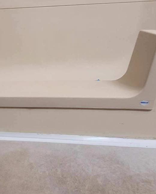 A close-up detail of a completed tub-to-shower conversion, showing the modified section by Tupelo Handyman in Tupelo, MS.