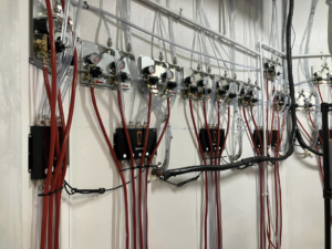 Detailed view of beverage system lines and control units installed in a cooler by Black Tide Beverage in Lakewood, CO.