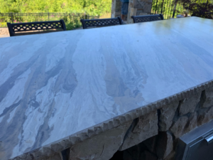 A close-up view of a detailed custom outdoor countertop with a unique finish by Burton Restoration LLC in Bend, OR.