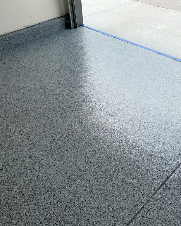 A detailed view of a shiny, finished epoxy garage floor by Apex Custom Coatings in Middleton, WI