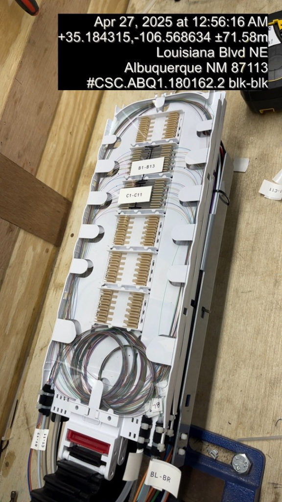A detailed view of fiber optic splicing connections within a tray, showcasing precision work by KPL Fiber Solutions LLC in Houston, TX.
