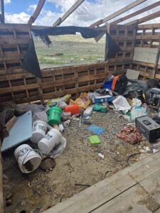 Interior of a dilapidated structure filled with trash, buckets, and debris, ready for cleanup by Rubble Removers LLC in Riverton, WY.