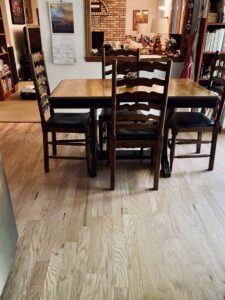 A cozy dining area showcasing light hardwood flooring, expertly installed by Nelson Hardwood Flooring in Madison, WI.