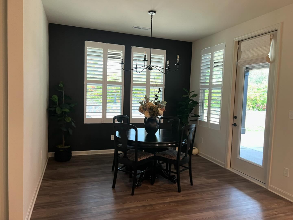 A beautifully painted dining room with a dark accent wall by Wilder Painting, LLC in Quincy, MA