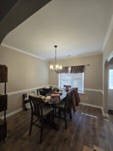 A dining room featuring newly installed crown molding and chair rail by Home FREA in Raleigh, NC.