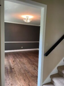 A view into a dining room or office space with dark hardwood flooring, installed by Nelson Hardwood Flooring in Madison, WI.