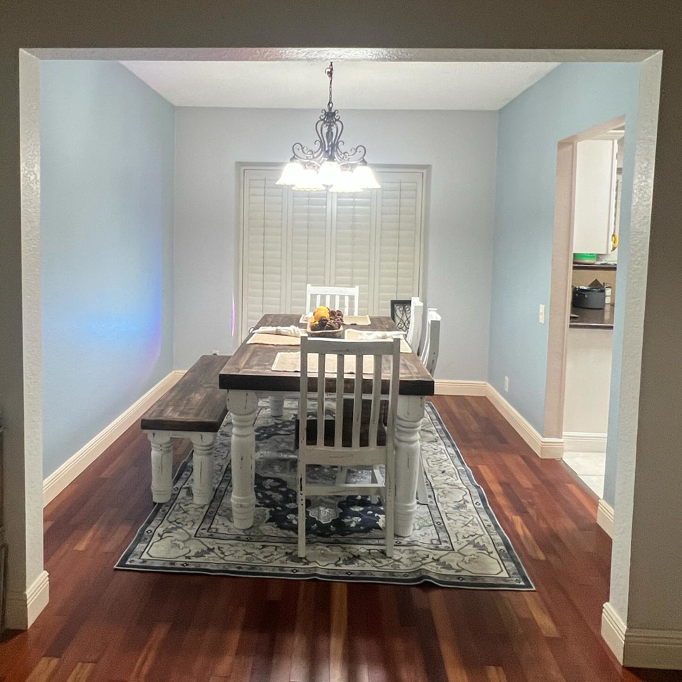 A beautifully painted dining room interior with light blue walls by The First Choice Painting in San Antonio, TX