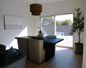 A dining room featuring a newly installed woven pendant light fixture, showcasing work by American Wolf Construction in Mesa, AZ