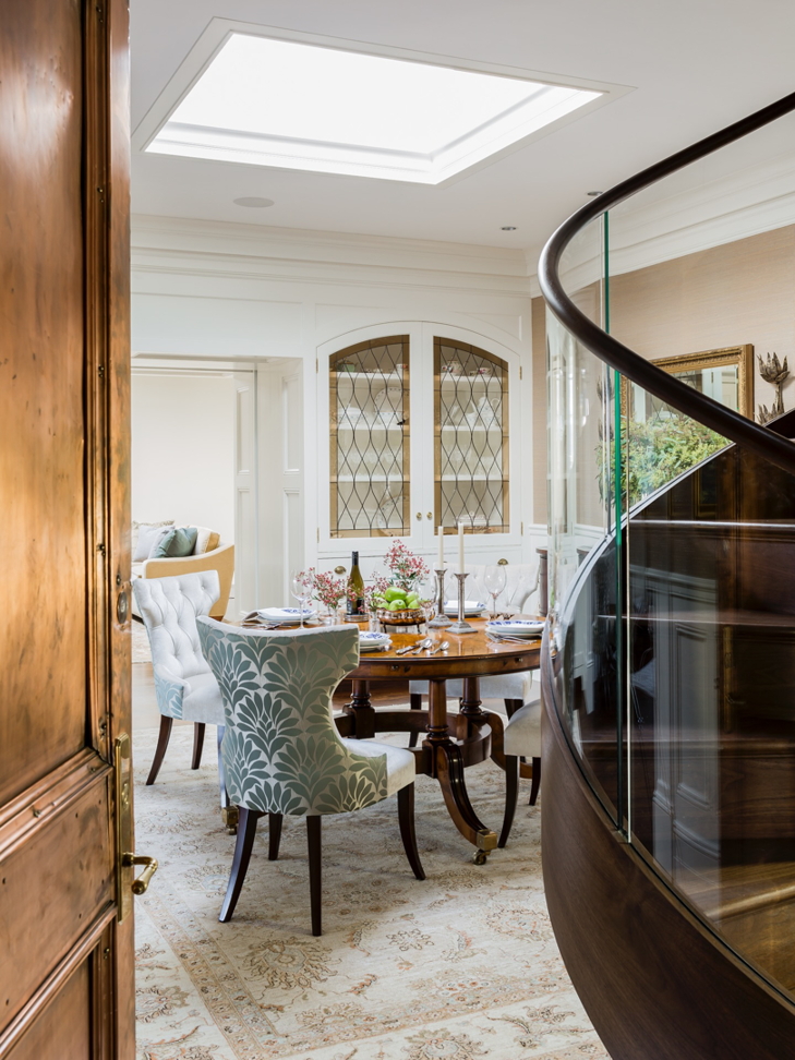 A beautifully renovated dining room featuring a skylight and custom built-in cabinet by FH Perry Builder in Hopkinton, MA.