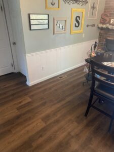 A dining area featuring new wainscoting and wood laminate flooring, a handyman project by Newhouse Construction St Louis in St. Louis, MO.