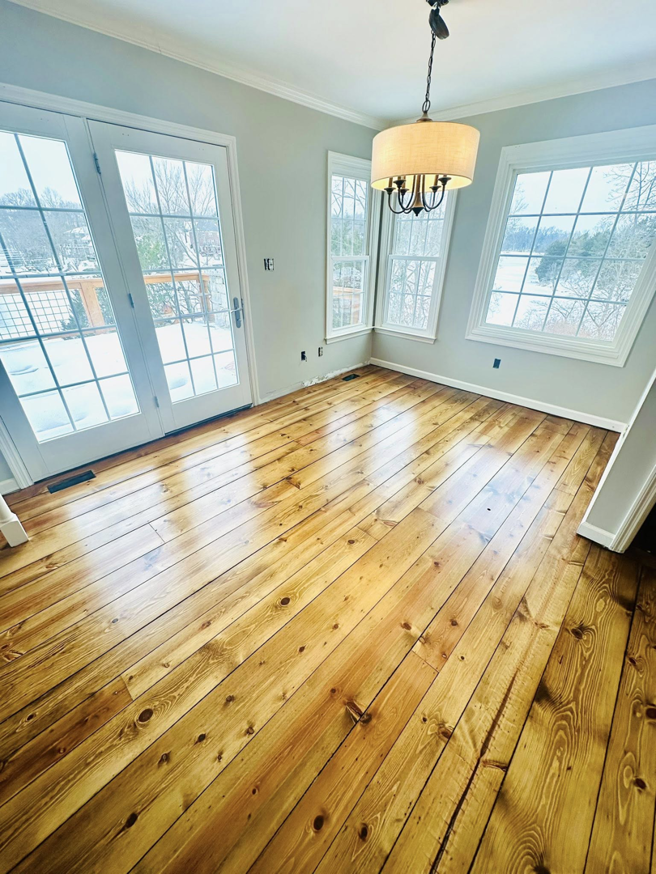 Dining room with elegant, newly refinished pine floors by WoodHaven Floor Refinishing in Georgetown, KY.