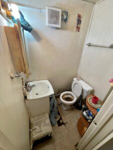 A very dirty bathroom with a stained toilet and sink, indicating a space ready for cleanout by Removall Residential and Commercial Cleanout Services in York, PA.