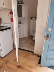 A dirty bathroom and kitchen area in a home needing junk removal by Paul's Trash in East Montpelier, VT.