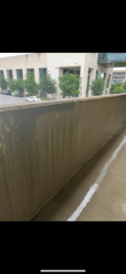 A dirty commercial wall showing grime buildup before cleaning by RWD Construction in San Antonio, TX.