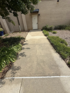 A dirty concrete sidewalk showing stains and grime, ready for professional cleaning by Ducky's Pro Wash in Mobile, AL.