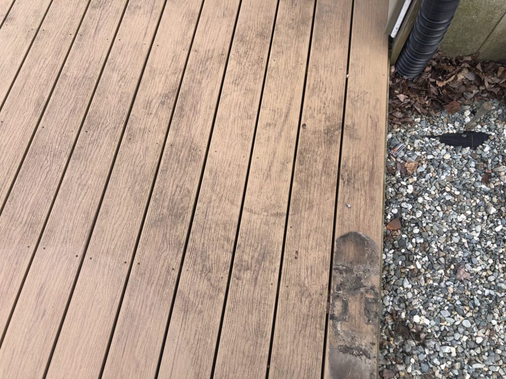 A dirty wooden deck surface in need of cleaning or maintenance from Phoenix's Cleaning Service, LLC in Rutland, VT.