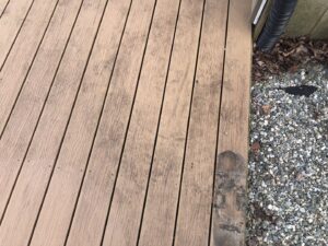 A dirty wooden deck surface in need of cleaning or maintenance from Phoenix's Cleaning Service, LLC in Rutland, VT.