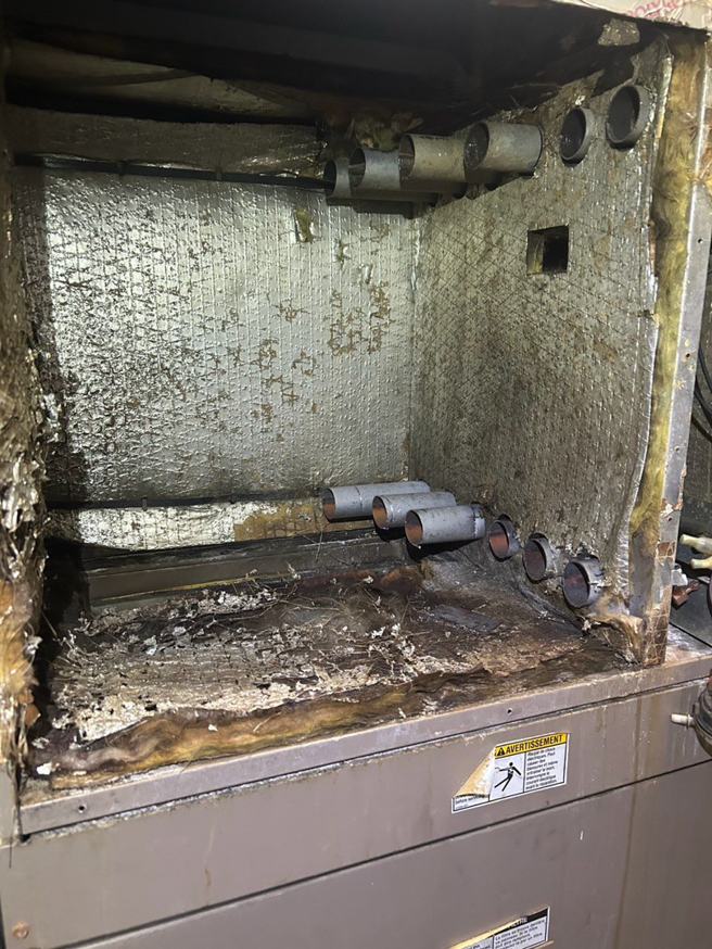 The dirty interior of an HVAC unit needing cleaning or repair by Comfort Mechanical Heating and Cooling in Ann Arbor, MI.