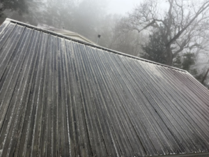 A dirty metal roof covered in grime and algae, ready for cleaning by Jeff's Exterior Washing in Summerville, SC.