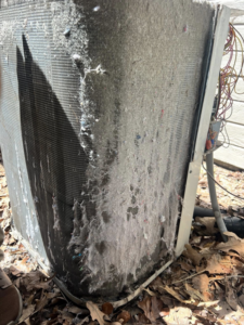 A dirty outdoor HVAC condenser unit needing cleaning, a service offered by ThermaPros in Leesburg, FL.