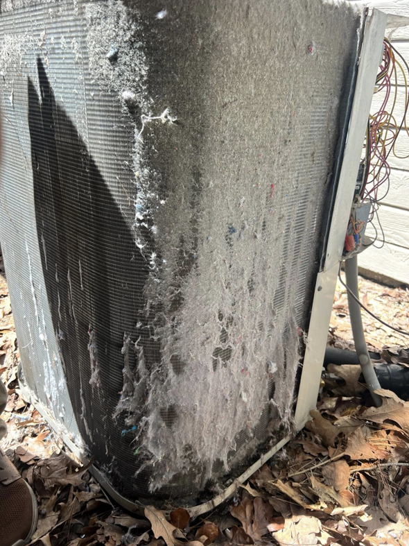 A dirty outdoor HVAC condenser unit needing cleaning, a service offered by ThermaPros in Leesburg, FL.