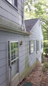 Exterior of a house showing dirty siding and gutters, indicating a need for cleaning by Rapid Repairs and Renovations in Knoxville, TN.