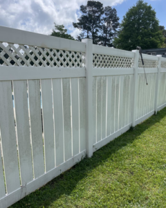 A dirty white vinyl fence before pressure washing by Comeaux Home Services in Baton Rouge, LA.