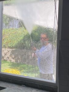 A dirty window with its screen removed, ready for professional cleaning by Bring The Pane in Lewiston, ID.
