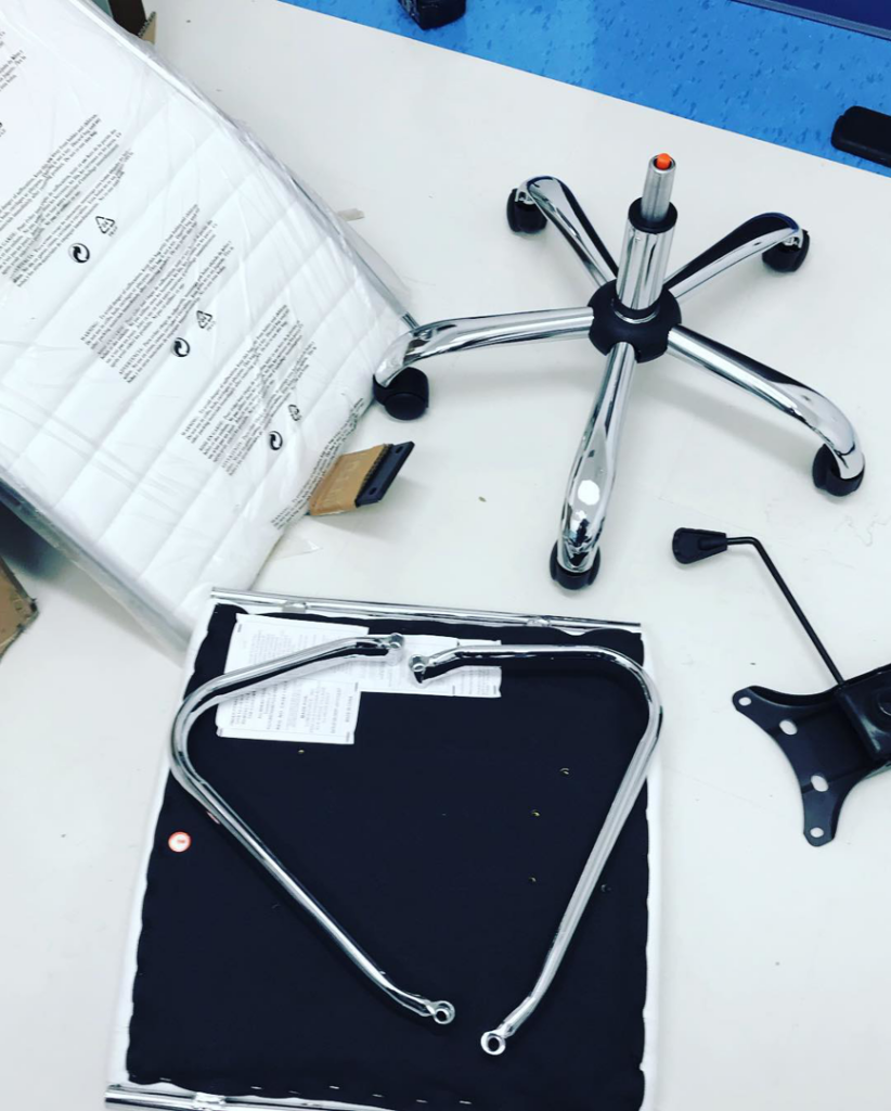 Disassembled parts of an office chair laid out for assembly, a service provided by KC Pro Assembly in Kansas City, MO.